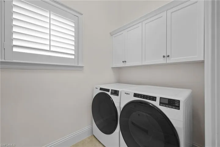 Laundry room, recent washer and dryer and sink with Quartz top