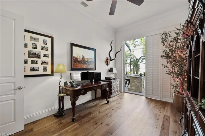 Office with slider to lanai and water view, new wood floor