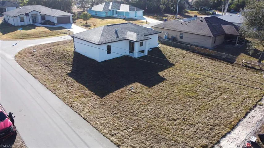 Prairie-style home featuring a front yard, stucco siding, and a garage