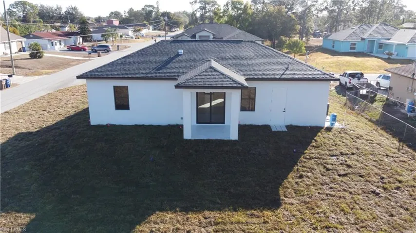 View of property exterior with a residential view and stucco siding