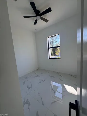 Spare room with baseboards and light marble finish flooring