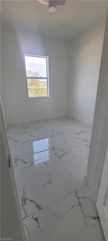 Unfurnished room featuring marble finish floors