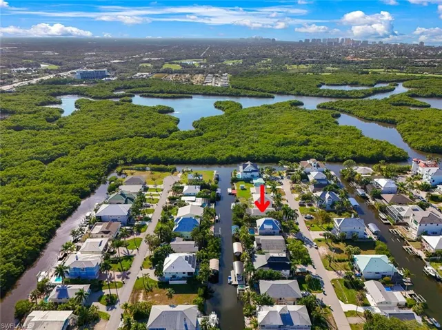 Aerial perspective of suburban area with a nearby body of water