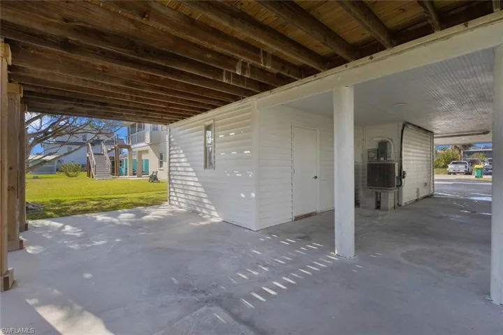 View of patio featuring stairway and an attached carport