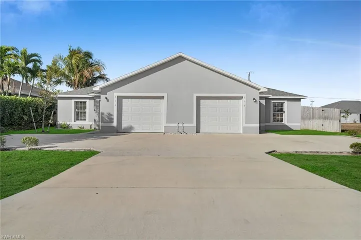 Ranch-style home with a garage, concrete driveway, and stucco siding