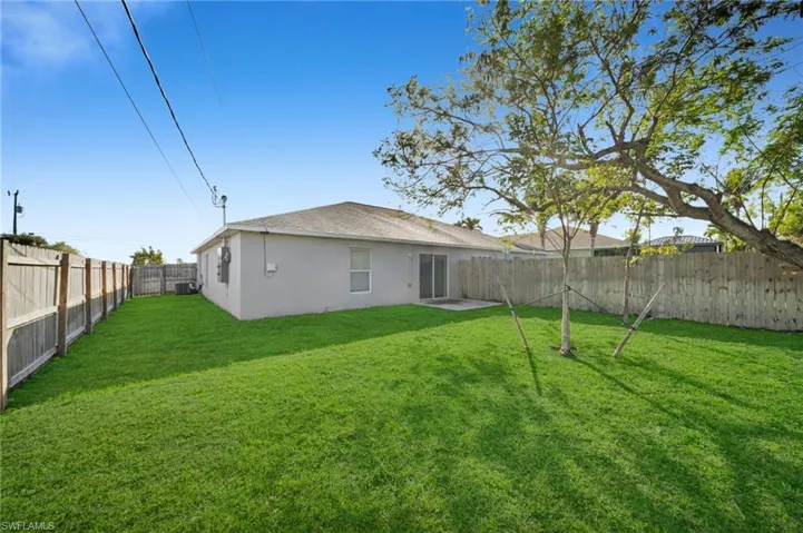 Back of property featuring a patio area, a fenced backyard, stucco siding, and a shingled roof