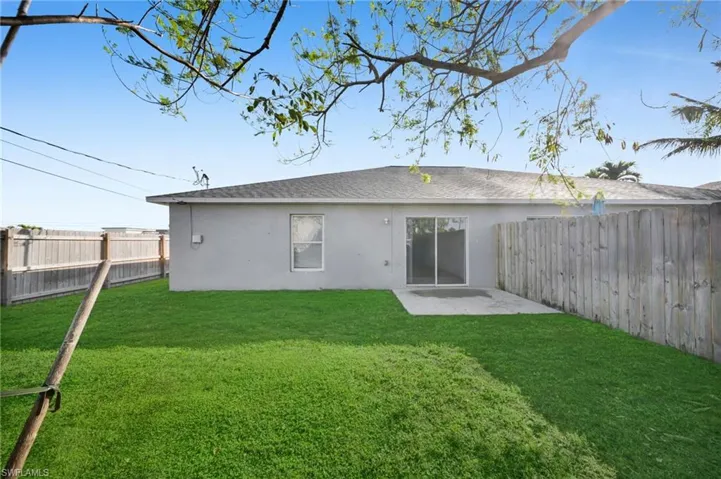 Back of house with a fenced backyard, a patio, stucco siding, and a shingled roof