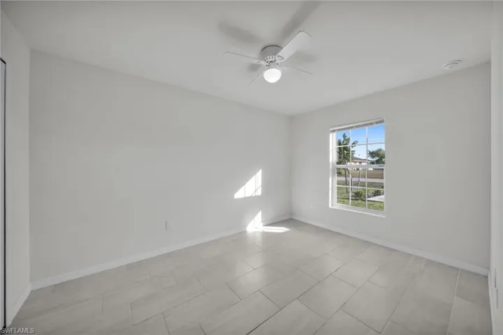 Spare room with baseboards and ceiling fan