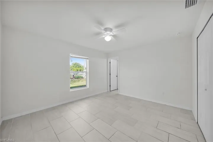 Unfurnished bedroom featuring a closet and a ceiling fan
