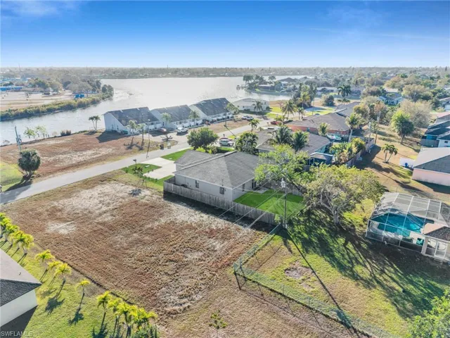 Aerial perspective of suburban area featuring a large body of water