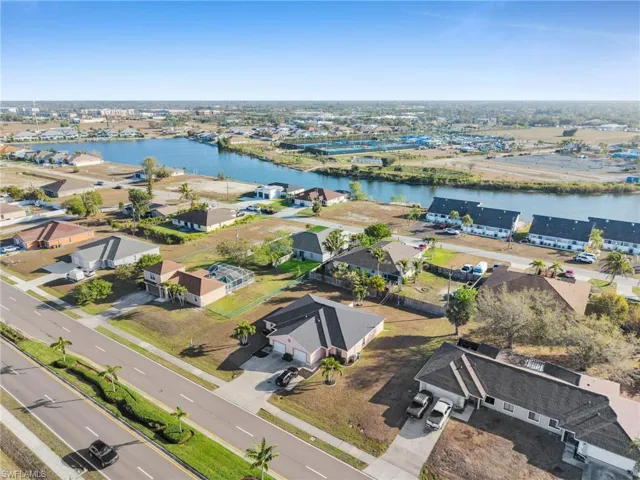 Aerial overview of property's location with a large body of water and nearby suburban area