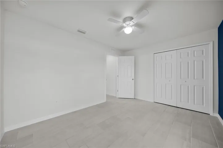 Unfurnished bedroom with a closet and a ceiling fan