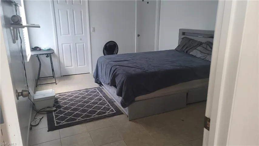 Bedroom featuring a closet and light tile patterned floors