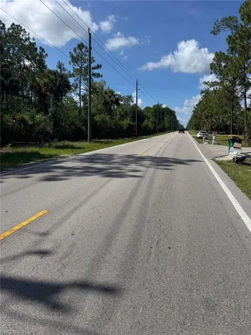 Paved road frontage with a clear sky backdrop