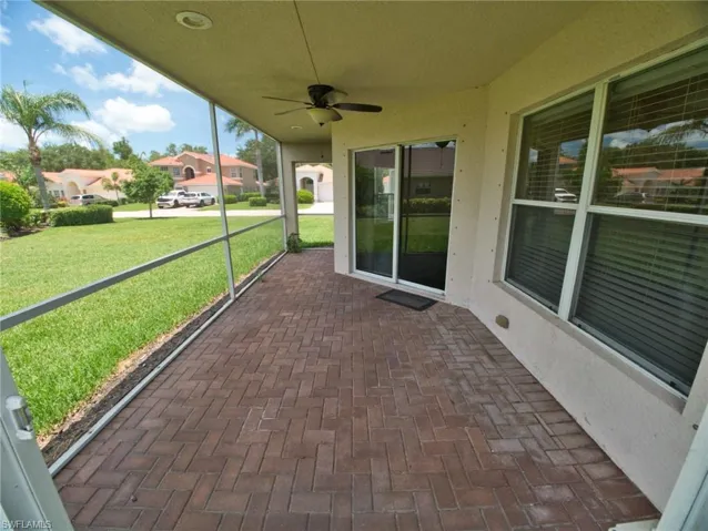 Screened patio featuring a ceiling fan, recessed lighting, and herringbone-patterned brick pavers