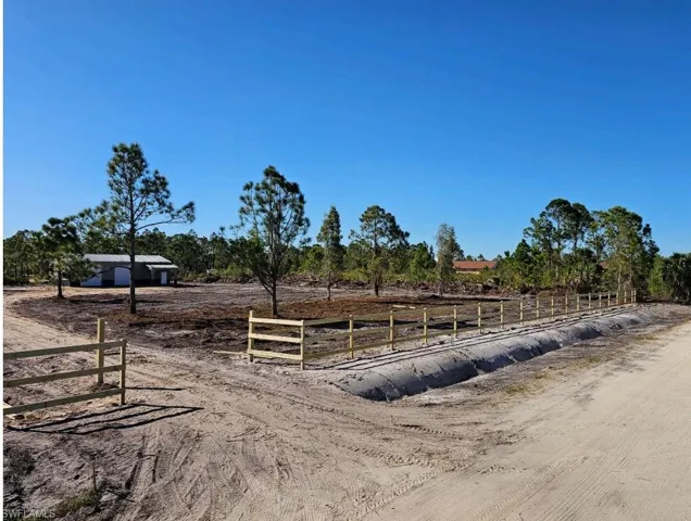 View of horse barn with a rural view