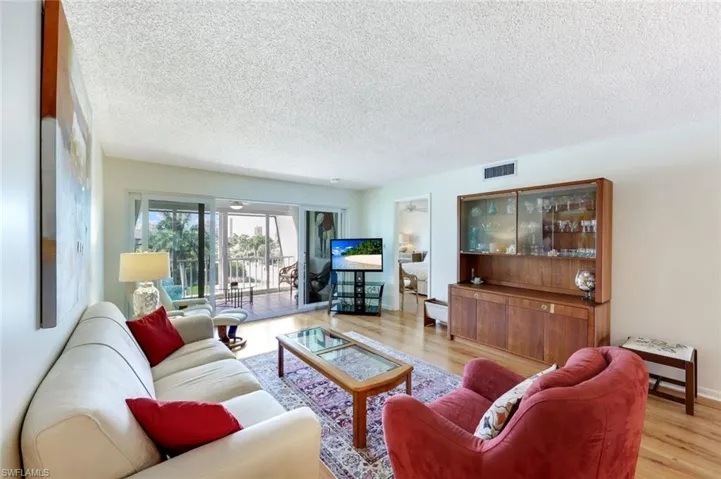 Living room with laminate wood floors and a textured ceiling
