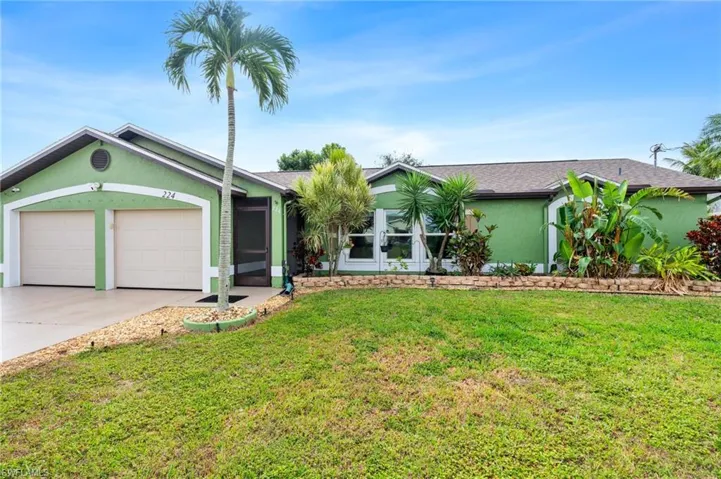 Ranch-style house featuring a garage and a front yard