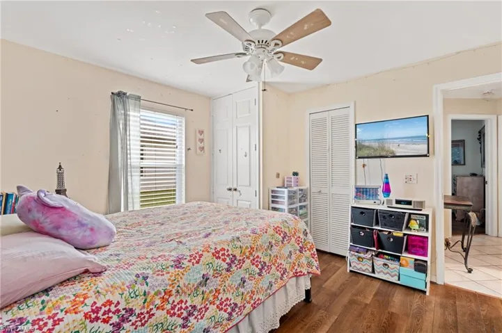 Bedroom featuring a closet, ceiling fan, and dark wood-type flooring