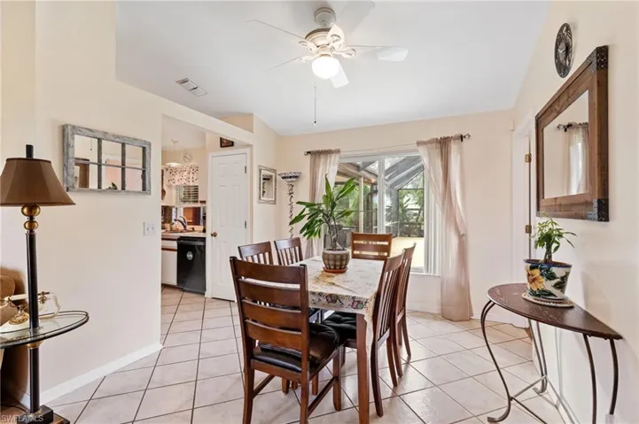 Dining area with ceiling fan, sink, and light tile patterned floors