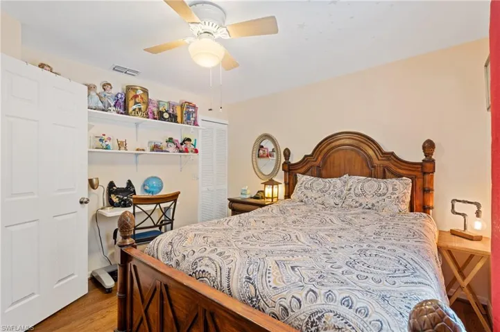 Bedroom featuring ceiling fan, light wood-type flooring, and a closet