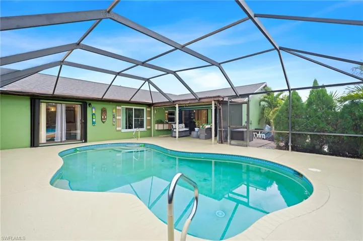 View of swimming pool featuring a patio area and a lanai