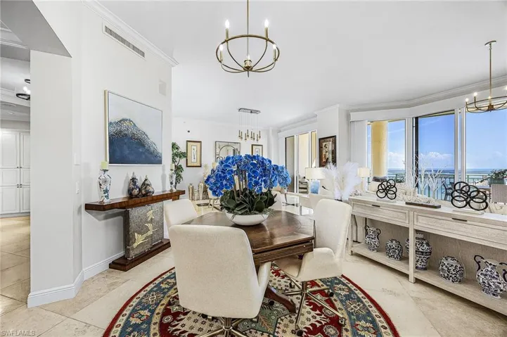Dining area featuring a chandelier and crown molding