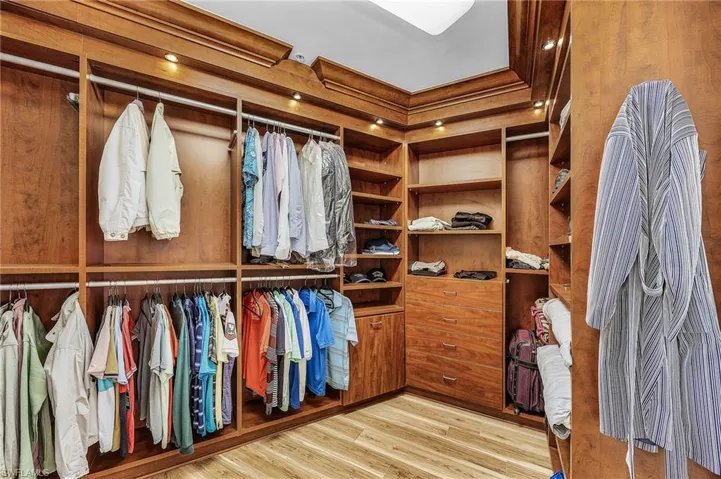 Spacious closet featuring light wood-style flooring