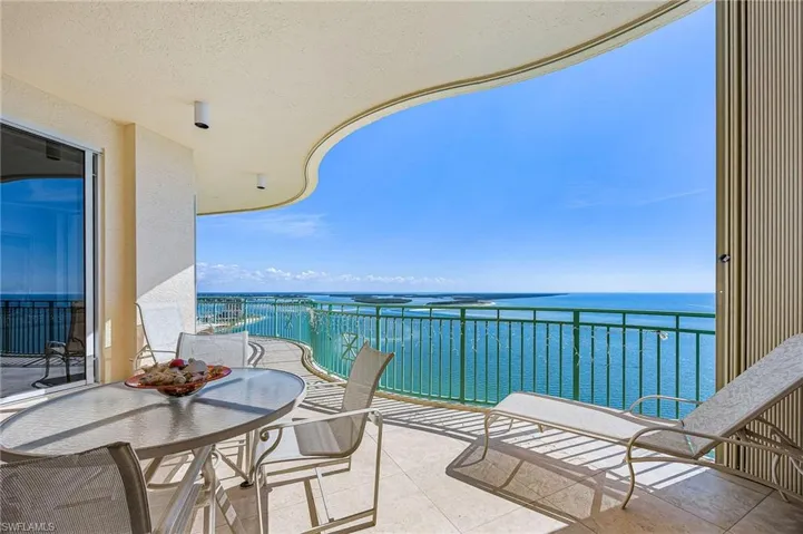 Balcony with a water view and outdoor dining area