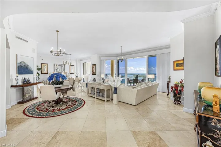 Living area featuring a chandelier and ornamental molding