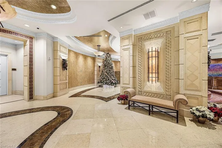 Community lobby featuring ornamental molding and recessed lighting