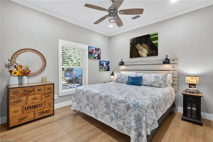 Bedroom with crown molding, light wood-type flooring, a ceiling fan, and recessed lighting