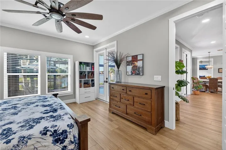 Bedroom featuring crown molding, light wood-style flooring, access to exterior, ceiling fan, and recessed lighting