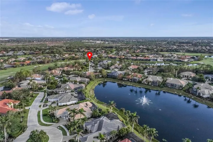 Birds eye view of property with a water view