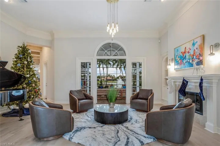 Living room featuring light wood-type flooring and crown molding