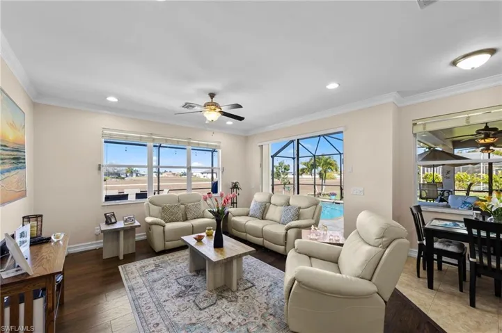 Living room with ceiling fan, crown molding, a sunroom, recessed lighting, and wood finished floors