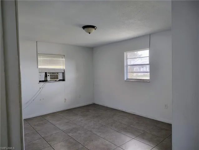 Interior room featuring tile flooring and white painted walls