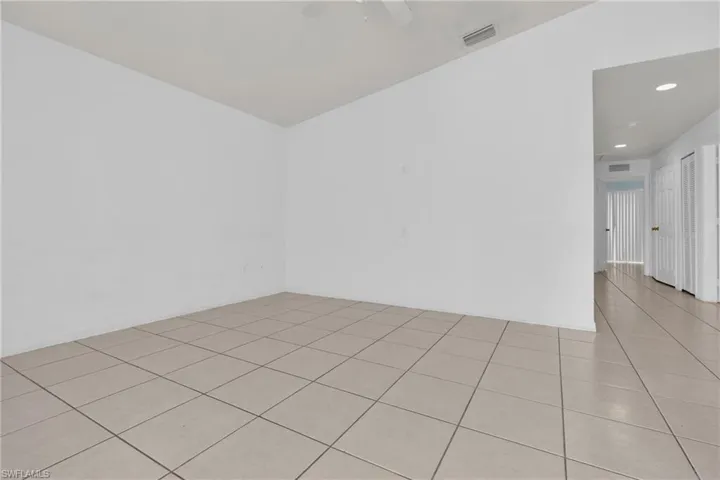 Spare room with light tile patterned flooring and a ceiling fan