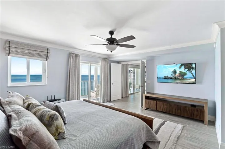 Bedroom with wood finished floors, crown molding, access to outside, and ceiling fan
