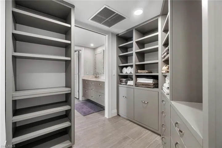 Spacious closet with light wood-style flooring