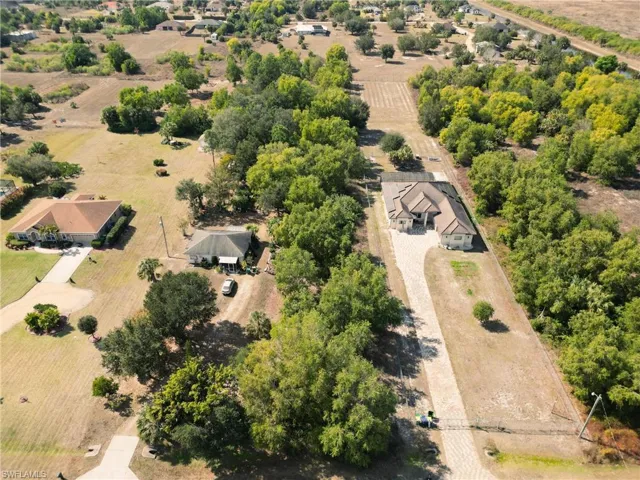 Aerial view of sparsely populated area with large plots for crops