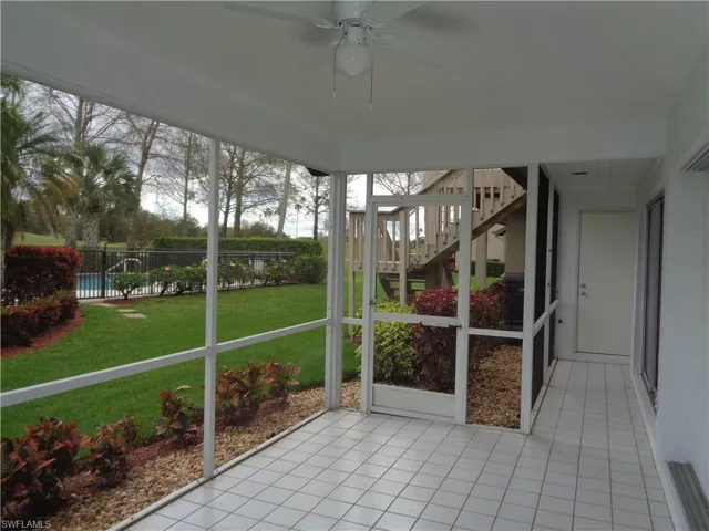 Unfurnished sunroom with a ceiling fan
