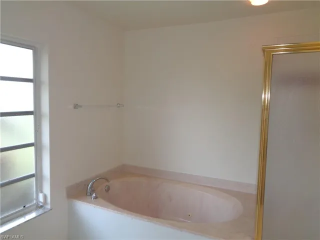 Full bath featuring a jetted tub