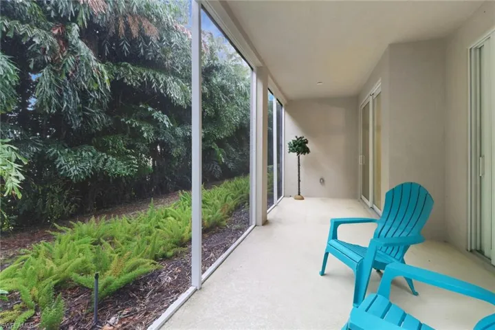 Large screened lanai overlooking lush landscape