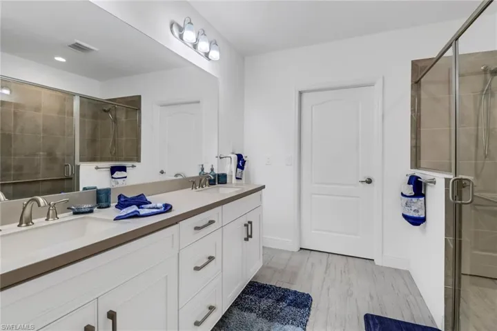 Bathroom with dual sinks and a shower