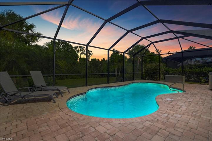 Pool at dusk with view of tthe preserve.