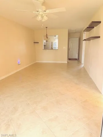 Unfurnished room featuring ceiling fan and light tile patterned floors