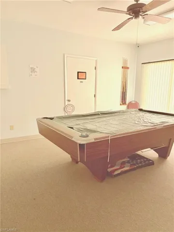 Game room with ceiling fan, carpet floors, and pool table