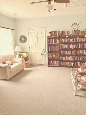 Living area with carpet and ceiling fan