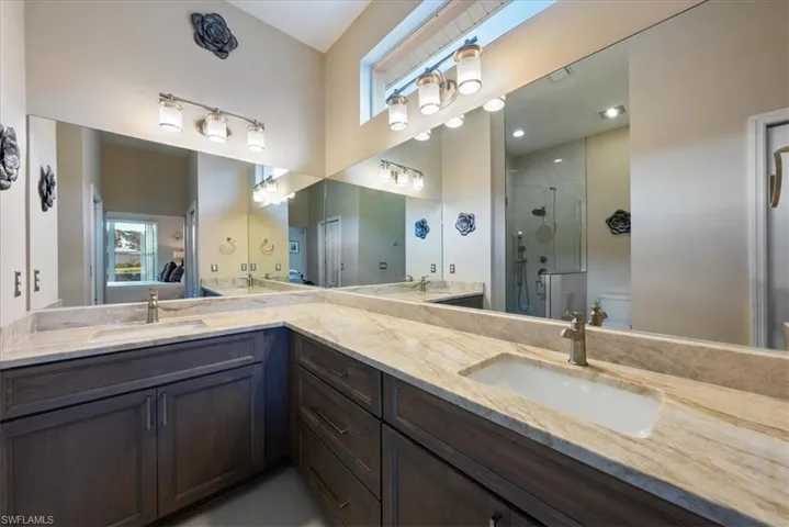 Bathroom with walk in shower, vanity, and toilet